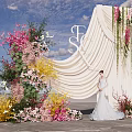 Wedding Photo Spot With Beige Drape Floral Decor And Bride In White Dress