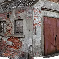 Old Industrial Factory Buildings With Weathered Brick Walls Roof Chimneys Green And Red Doors