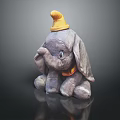 Gray Elephant Themed Furniture Decor Piece With Yellow Hat And Orange Bow On Black Base