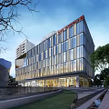 Modern Office Building Exterior With Glass Curtain Wall Surrounding Green Plants And Night Lighting