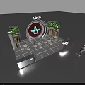 Exhibition Reception Desk Featuring Circular Logo Black Bottle Design Green Screens And Light Tables Chairs