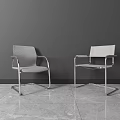 Two Modern Office Chairs With Metal Frame And Gray Design In Minimalist Workspace