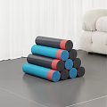 Stacked Blue Black And Red Exercise Mats On Wooden Floor In Living Room