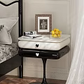 Elegant Black And White Bedside Table With Framed Picture Books And Lemon Bowl
