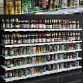 Display Shelves With Multiple Layers Holding Various Beer Bottles In Retail Store