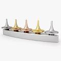 Metallic Conical Decorative Pieces In Silver Gold Copper Colors Arranged On Base With Standalone Design