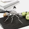 Mechanical Metal Ant Decorative Ornament Set with Stacked Books and Green Apples on Black Table