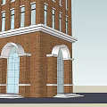 The Red Brick Clock Tower With Spire Multi Story Windows And Arched Doors