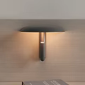 Modern Metal Wall Lamp with Dark Shade and Cylindrical Design on Wooden Wall