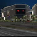 Illuminated Modern Commercial Complex With Glass Facade Palm Trees And Car In Foreground