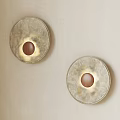 Two Circular Wall Sconces with Textured Design and Warm Light on Light Colored Wall 3d model
