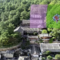 Traditional Modern Guesthouse Architecture with Sloped Wooden Roofs and Lush Green Surroundings