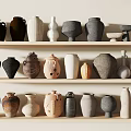 Ceramic Vessels Displayed on Three Tiered Shelves With Various Colors Different Shapes And Sizes