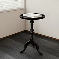 Black Round Top Side Table With Tray Design And Curved Legs In Corner
