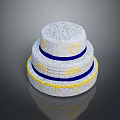Three Tier White Cake with Blue Ribbons Yellow Heart Patterns and Drizzle Design