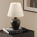 Table Lamp with Dark Ceramic Base and Light Linen Shade on Table with Book 3d model