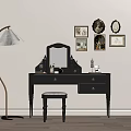 Black Dressing Table with Mirror Stool Gold Framed Pictures and Floor Lamp in Interior