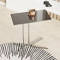 Modern Minimalist Side Table With Black Tabletop And Metal Legs Featuring Coffee Cup On Top