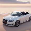 Elegant White Audi Convertible Parked On Beach At Sunset With Ocean View