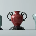 Ceramic Vessels In Turquoise And Red With Decorative Handles And Textured Surfaces