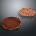 Two Round Wooden Coffee Tables With Carved Edges And Slim Legs On Dark Background