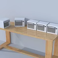 Five White Microwaves On Wooden Table Against Light Blue Wall Kitchen Appliances