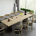 Wooden Dining Table Set With Eight Chairs Black Cushions Vase Decorations And Green Plants