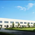 Modern Industrial Factory Complex With Multiple Buildings Greenery Parking And Access Road