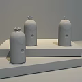 Three Different Colored Small Daily Electrical Appliances With Decorative Tops On Yellow Display Stands