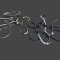 Intricate Twisted Metallic And Black Leather Decorative Objects With Silver Accents