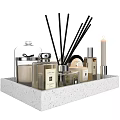 Elegant Decorative Ornament Set Featuring Reed Diffusers Candles And Fragrance Bottles On Textured Tray