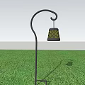 Outdoor Lantern With Yellow Diamond Pattern And Black Curved Metal Stand On Green Grass