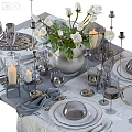 Elegant Dinnerware Set With White Flowers Vase Candles Glassware And Silver Cutlery