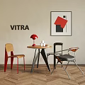 Stylish VITRA Table And Chair Set With Round Wooden Table Red Lamp And Geometric Artwork