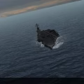 Military Aircraft Carrier Sailing in Open Sea With Numerous Fighter Jets on Deck