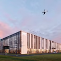 Modern Industrial Factory Building with Glass Curtain Wall Lighting People Around Drone Flying Sunset Sky
