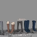 Knee High Boots In Gray Brown And Navy Blue Colors Neatly Arranged On White Shelf