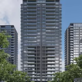 Modern High Rise Building Exterior With Green Trees And Blue Sky View