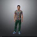 A Man Wearing Colorful Patterned T-Shirt Green Pants And Blue Shoes Against Gray Background