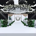 Banquet Hall With White Aisle Green Plant Decorations And Crystal Chandelier Lighting