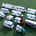 Various Types of RV Camper Van Models Displayed on Green Grass