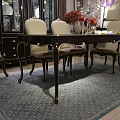 Dark Wooden Dining Table With Elegant Curved Legs And Metal Accents