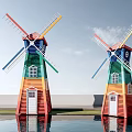 Colorful Windmills With Red Yellow Green Blue Stripes Under Blue Sky And Water Reflections