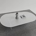 White Oval Perforated Coffee Table With Gray Vase And Square Object On Gray Carpet 3d model