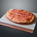 Freshly Baked Round Bread on Wooden Board with Golden Brown Texture