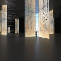 Art Installation With Tall Columns Featuring Calligraphy In Spacious Modern Interior With Standing Person