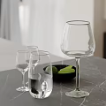 Elegant Modern Decorative Ornament Set With Glassware Black Bowl Green Fruits On Gray Countertop