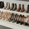 Various Styles And Colors Of Boots High Heels Neatly Arranged On White Stepped Display Shelf