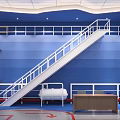 Industrial Space With Blue Wall White Staircase Metal Railing And Wooden Table
