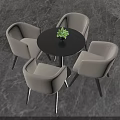 Round Black Table with Four Beige Chairs and Small Green Plant